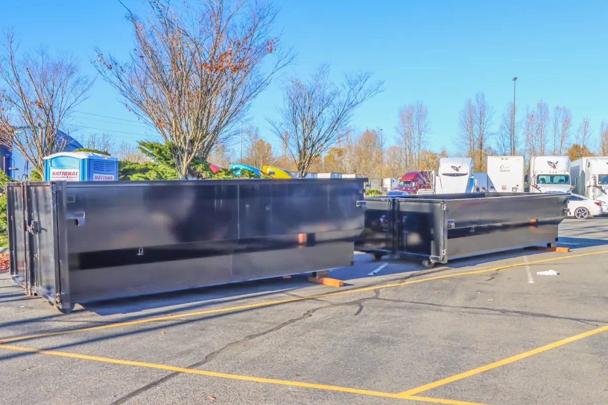 Professional dumpster rental service with roll-off container on residential driveway in Menomonie